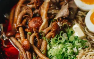 Μπολ ramen με μανιτάρια Kakumi, ψιλοκομμένο φρέσκο κρεμμυδάκι, μισά αυγά μελάτα και πλούσιο ζωμό.